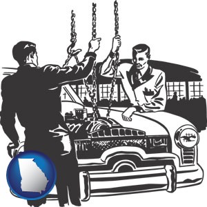 auto mechanics hoisting an engine out of a car with chains - with Georgia icon